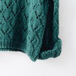 green knitted top