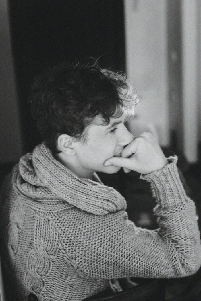 grayscale photo of boy in sweater